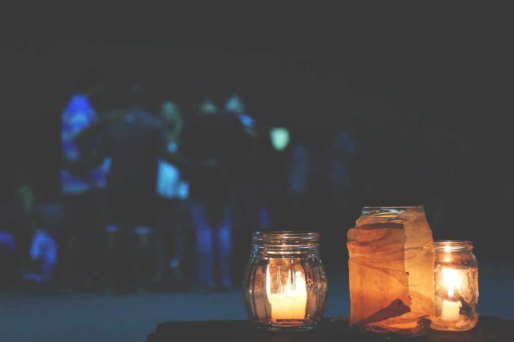 glowing lit candles on a table at night