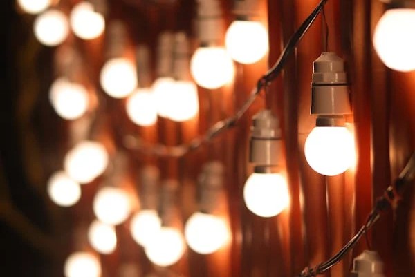 drape string lights on the face of a fence for a wall of light